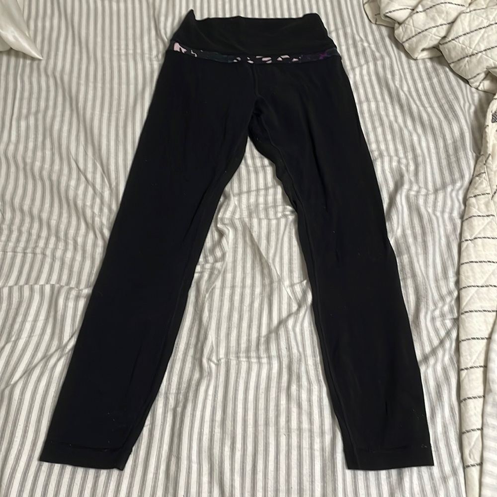 Lululemon leggings in black with a purple and pink band at the top